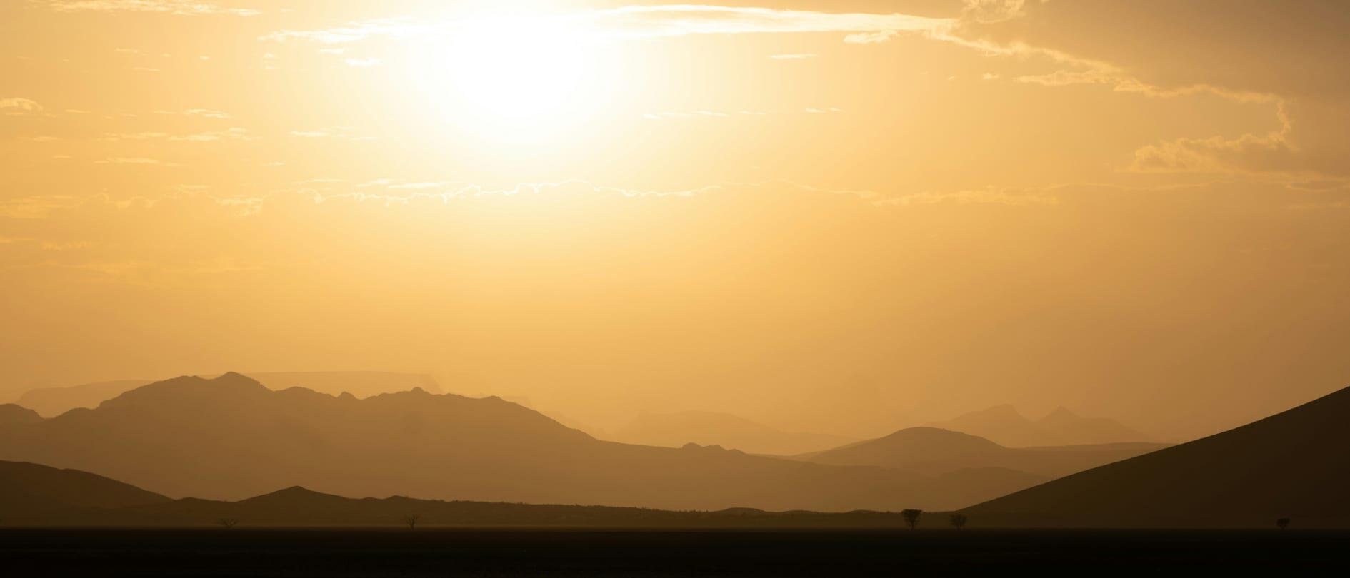 A hazy, glowing sunset over desert mountain ridges – months before its expected peak, the 2026 super El Niño has passed the highest temperature ever recorded for the phenomenon