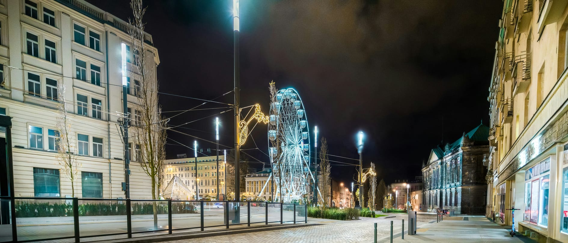 A European city centre at night, lined with nineteenth-century apartment blocks – the densely built, pre-standard residential stock to which the renovation obligations of the recast EPBD apply