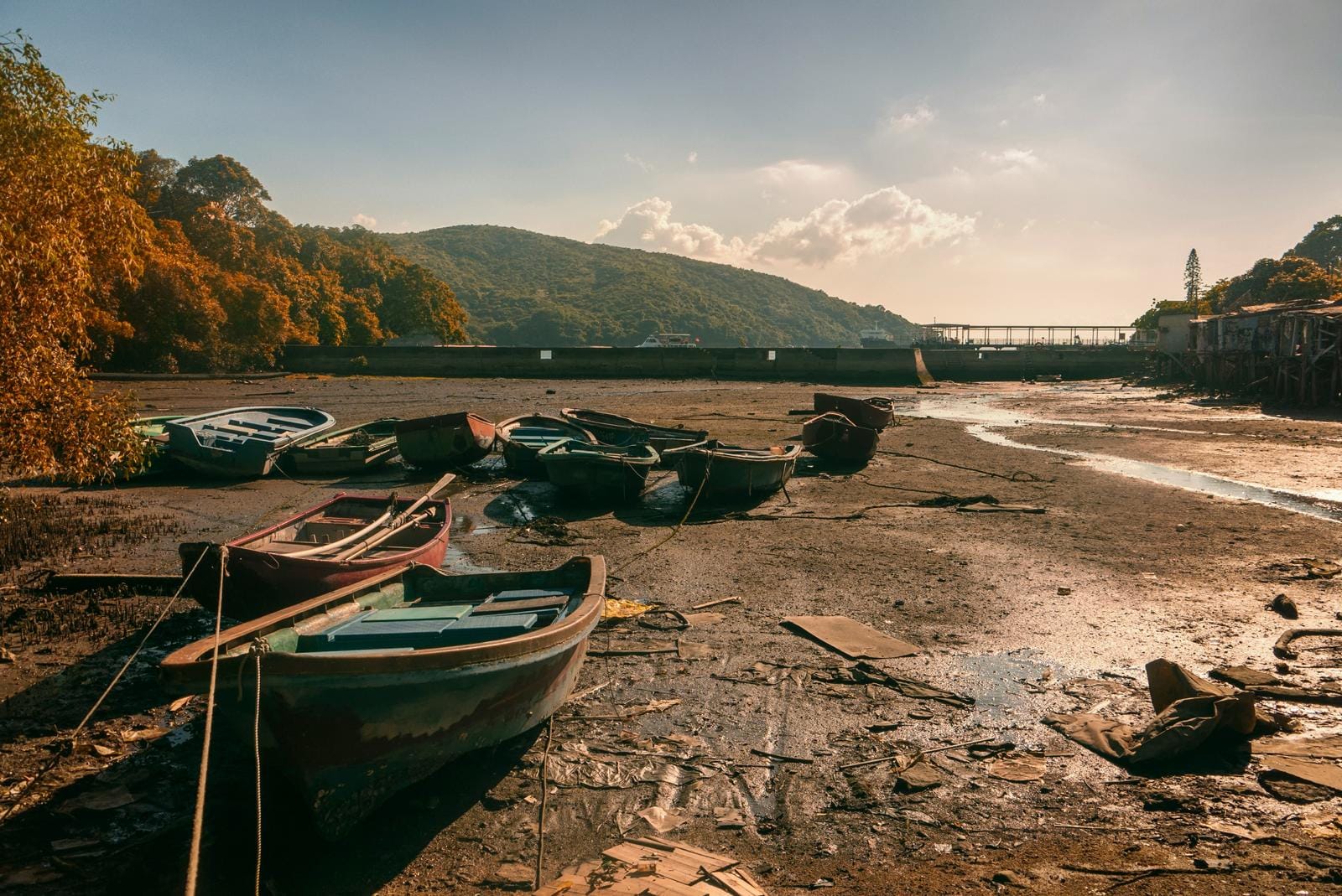Beached rowing boats on the muddy bed of a dried-out river channel - illustrating the record-low water levels recorded across Hungary in 2026