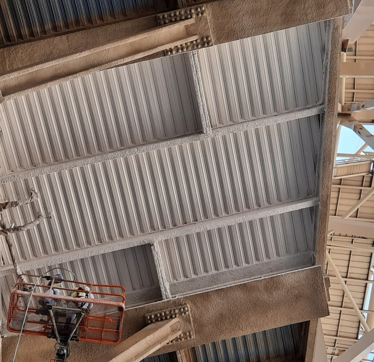 GWR NANO INSULATION® being applied to metal decking inside Lusail Stadium - operatives working from an elevated work platform