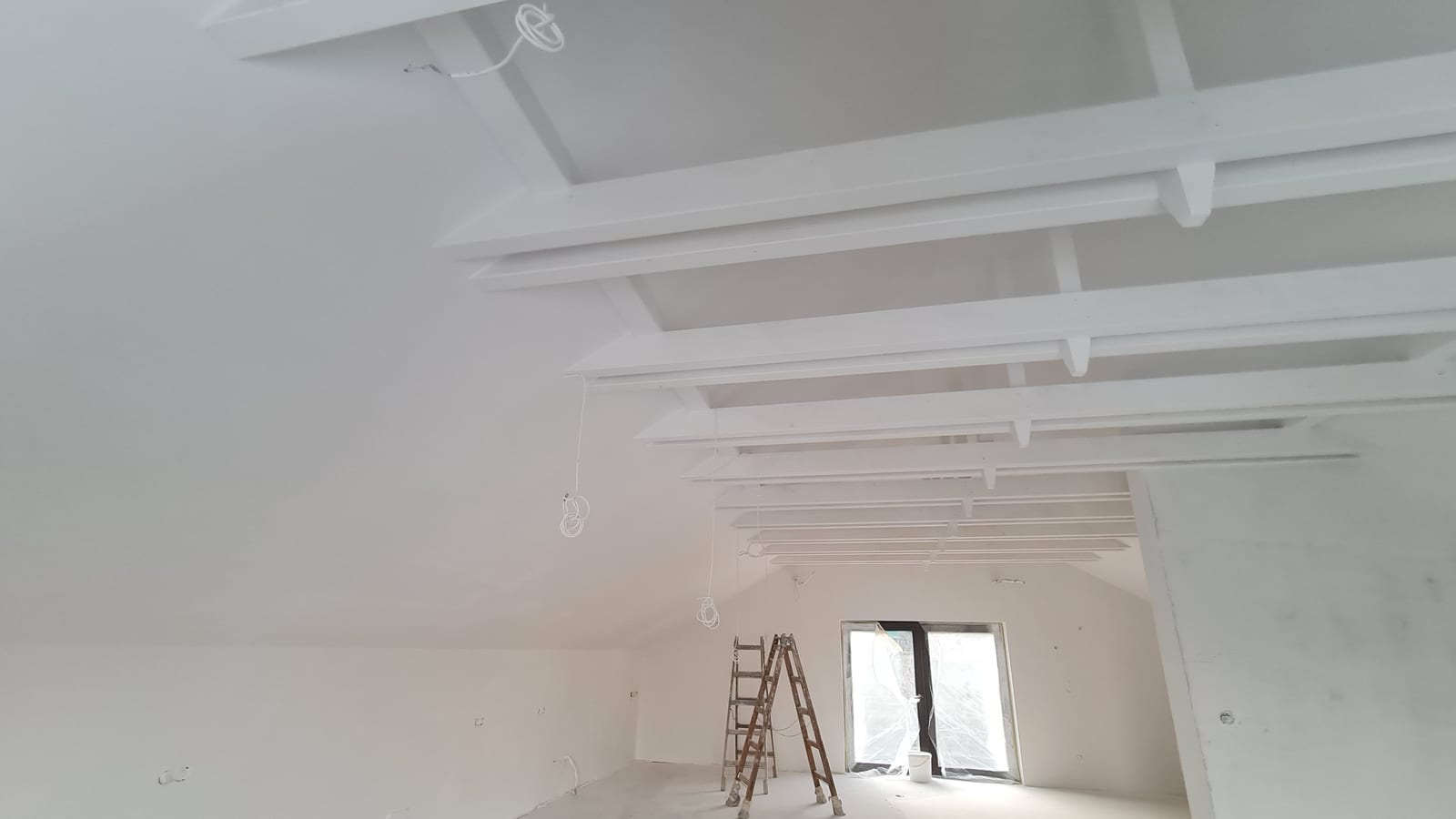 Interior surfaces of an attic with a GWR NANO INSULATION® coating — coated sloping roof plane, exposed framing and gable wall, Budapest District III
