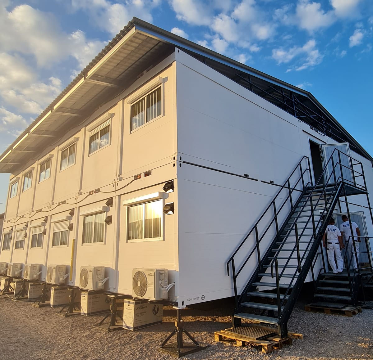 Two-storey modular container accommodation complex with a GWR NANO INSULATION® coated external panel envelope, external steel stair and ground-floor air-conditioning units, Butmir, Bosnia and Herzegovina